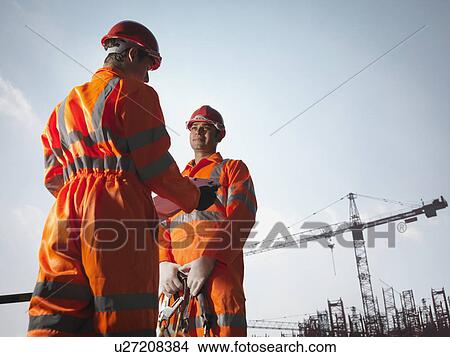 Picture - Workers With Notes And Cranes. Fotosearch