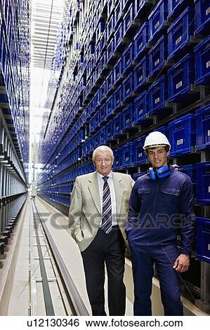 Stock Photograph - workman and boss in storage. Fotosearch