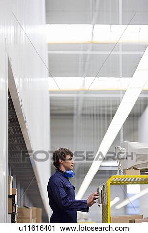 Stock Image - workman at workplace. Fotosearch
