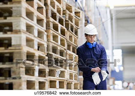 Stock Image - workman in storage. Fotosearch