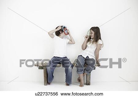 Young boy and girl smiling at each other View Large Photo Image Stock Photograph - Young boy and girl smiling at each other. Fotosearch