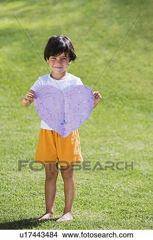 Picture - Young boy holding purple paper heart. Fotosearch
