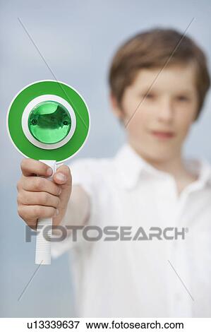 Stock Photo - young boy holding up go sign. Fotosearch