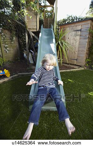 Picture - Young boy on a slide. Fotosearch
