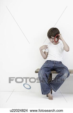 Young boy playing with plastic rings View Large Photo Image Picture - Young boy playing with plastic rings. Fotosearch