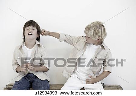 Young boys pretend fighting View Large Photo Image Stock Image - Young boys pretend fighting. Fotosearch