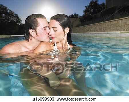 Stock Image - young couple in pool. Fotosearch