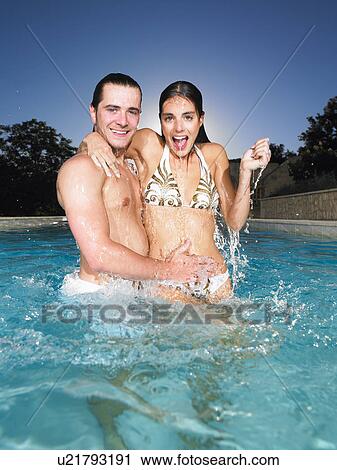 Stock Image - young couple in pool. Fotosearch