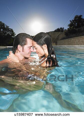 Stock Photo - young couple in pool. Fotosearch