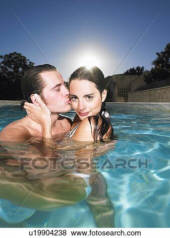 Stock Photo - young couple in pool. Fotosearch