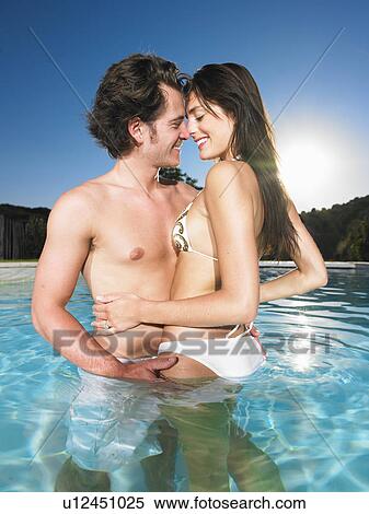 Stock Photography - young couple in pool. Fotosearch