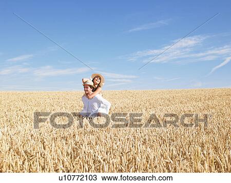 Stock Image - young couple in wheat field. Fotosearch