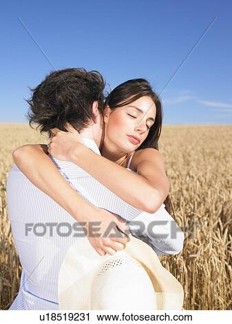 Stock Image - young couple in wheat field. Fotosearch