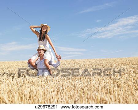 young couple in wheat field View Large Photo Image Stock Image - young couple in wheat field. Fotosearch