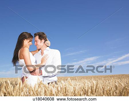 young couple in wheat field View Large Photo Image Stock Photo - young couple in wheat field. Fotosearch