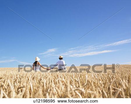 Stock Photography - young couple in wheat field. Fotosearch