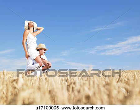 Stock Photography - young couple in wheat field. Fotosearch