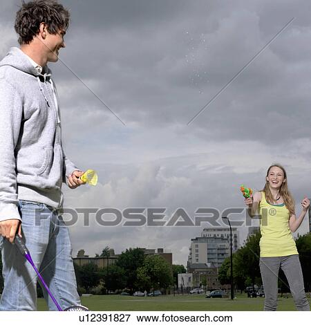 Young couple shooting water pistol View Large Photo Image Stock Photo - Young couple shooting water pistol. Fotosearch