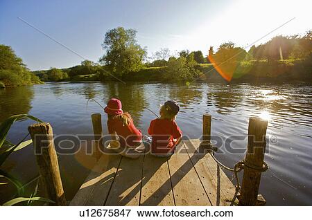 Stock Photo - Young girl and boy fishing.. Fotosearch