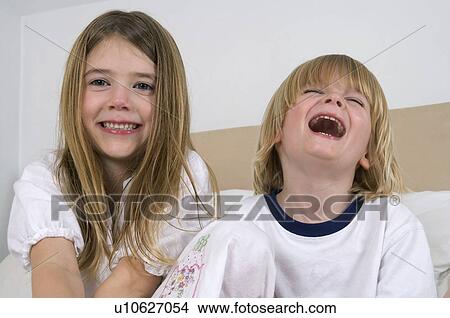 Picture - Young girl and boy laughing.. Fotosearch