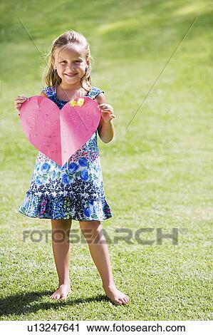 Young girl holding red paper heart View Large Photo Image Stock Image - Young girl holding red paper heart. Fotosearch