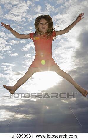 Young girl jumping into the air View Large Photo Image Stock Image - Young girl jumping into the air. Fotosearch