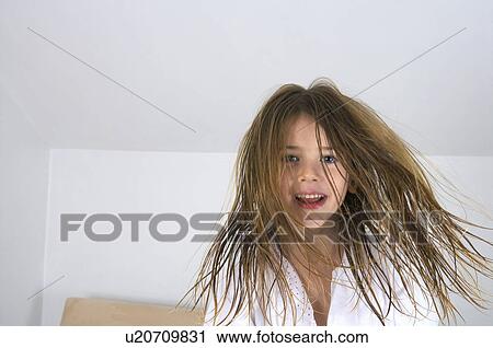 Young girl jumping on a bed. View Large Photo Image Stock Image - Young girl jumping on a bed.. Fotosearch