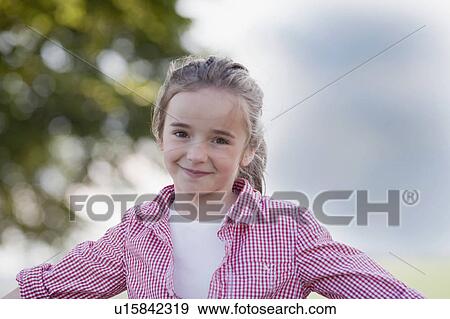 Stock Photo - young girl playing smiling at viewer. Fotosearch