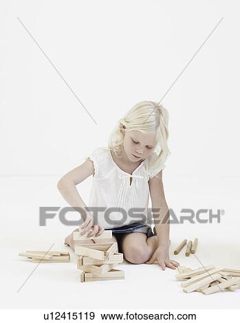 Young girl playing with building blocks View Large Photo Image Stock Photo - Young girl playing with building blocks. Fotosearch