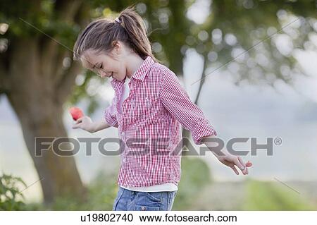 young girl playing with flowers View Large Photo Image Stock Image - young girl playing with flowers. Fotosearch