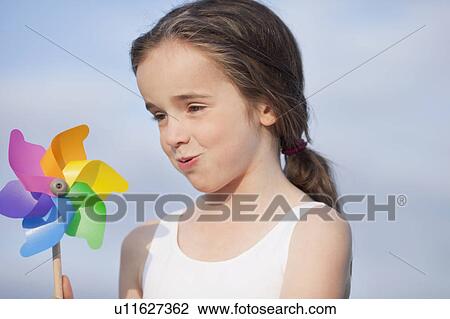 young girl playing with toy windmill View Large Photo Image Stock Image - young girl playing with toy windmill. Fotosearch