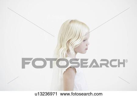 Stock Image - Young girl thinking, profile. Fotosearch