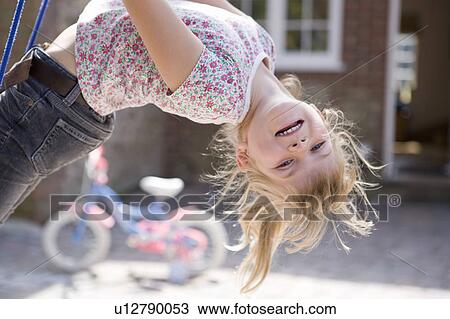Young girl upside down on swing View Large Photo Image Stock Image - Young girl upside down on swing. Fotosearch