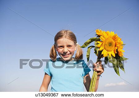Stock Photo - Young Girl With Sunflower Spray. Fotosearch