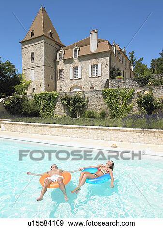 young man and woman floating in pool View Large Photo Image Stock Photo - young man and woman floating in pool. Fotosearch