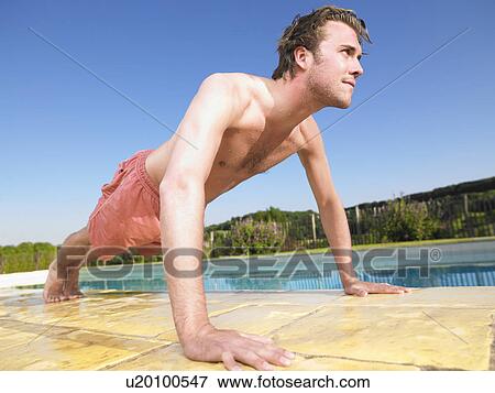 Stock Photo - young man doing push ups. Fotosearch