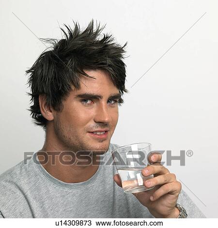 Stock Image - young man drinking a glass of water. Fotosearch