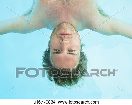 young man floating in water View Large Photo Image Picture - young man floating in water. Fotosearch