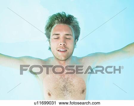 young man floating in water View Large Photo Image Stock Image - young man floating in water. Fotosearch