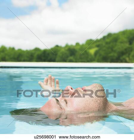 young man floating in water View Large Photo Image Stock Image - young man floating in water. Fotosearch