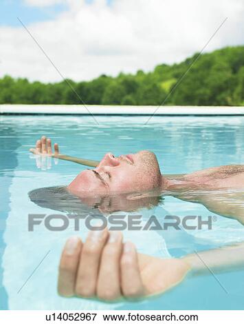 young man floating in water View Large Photo Image Stock Photo - young man floating in water. Fotosearch