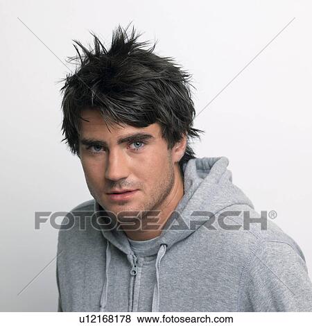 Young man in grey hooded top View Large Photo Image Stock Photo - Young man in grey hooded top. Fotosearch