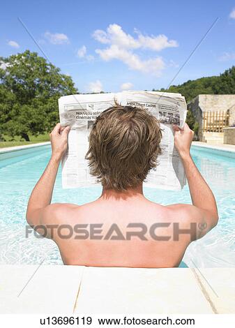 young man reading newspaper View Large Photo Image Stock Photo - young man reading newspaper. Fotosearch