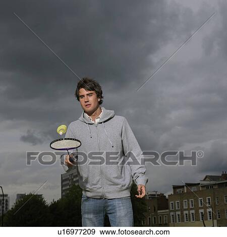 Stock Photo - Young man with badminton racket. Fotosearch