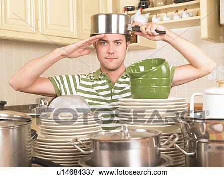 Stock Photo - young man with pan on head. Fotosearch