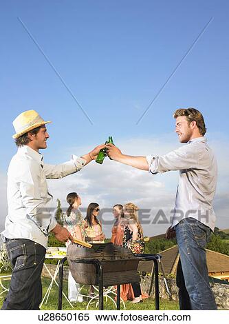 young men tending barbecue View Large Photo Image Stock Photography - young men tending barbecue. Fotosearch