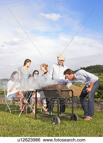 young people having barbecue View Large Photo Image Stock Photograph - young people having barbecue. Fotosearch