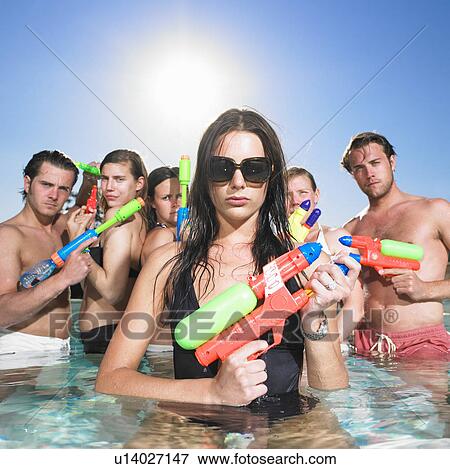 young people posing with water guns View Large Photo Image Stock Photo - young people posing with water guns. Fotosearch