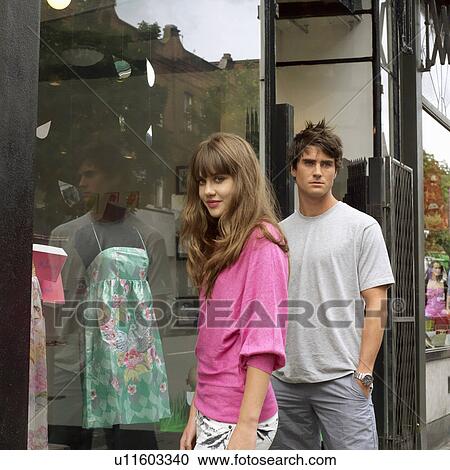Young woman and man outside a shop View Large Photo Image Stock Image - Young woman and man outside a shop. Fotosearch