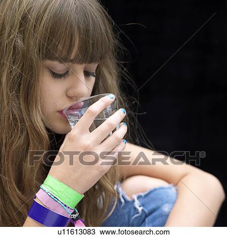 young woman drinking from a glass View Large Photo Image Stock Image - young woman drinking from a glass. Fotosearch